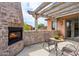 Outdoor patio featuring a stone fireplace and a pergola, perfect for relaxing or entertaining guests at 7701 E Golden Eagle Cir, Gold Canyon, AZ 85118