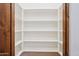 Walk-in pantry with wooden trim and multiple shelves perfect for storage at 7701 E Golden Eagle Cir, Gold Canyon, AZ 85118