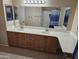 Bathroom features a double vanity and large mirror, complemented by modern fixtures and a shower with a blue curtain at 10136 E Southern Ave # 2048, Mesa, AZ 85209