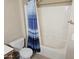 Bathroom view of the white tub and toilet complete with a blue striped curtain at 10136 E Southern Ave # 2048, Mesa, AZ 85209