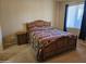 Bedroom featuring a bed with a patterned quilt, and a side table at 10136 E Southern Ave # 2048, Mesa, AZ 85209