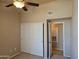 Bedroom with neutral walls, bi-fold door closet, and a view into a doorway at 10136 E Southern Ave # 2048, Mesa, AZ 85209