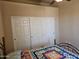 Bright bedroom featuring a closet with white bi-fold doors, and colorful patterned quilt at 10136 E Southern Ave # 2048, Mesa, AZ 85209