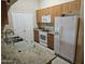 Well-equipped kitchen featuring granite countertops, stainless steel sink, and white appliances at 10136 E Southern Ave # 2048, Mesa, AZ 85209