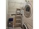 Inside view of the laundry room, with shelving, laundry machines, and step ladder at 10136 E Southern Ave # 2048, Mesa, AZ 85209