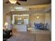 Open-concept space showcasing the kitchen, dining area with blue chairs, and living area with neutral carpet at 10136 E Southern Ave # 2048, Mesa, AZ 85209