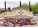 View of the Coyote Landing Condominiums sign, complete with vibrant floral accents at 10136 E Southern Ave # 2048, Mesa, AZ 85209