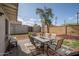 Cozy backyard patio with outdoor dining set, seating, umbrella, and desert landscape at 1108 N Esther St, Tempe, AZ 85288