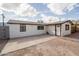 Charming single-story home with a clean white facade, dark trim, and ample parking at 1108 N Esther St, Tempe, AZ 85288