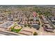 Expansive aerial view of a well-planned community with a playground and desert landscaping at 11343 W Mccaslin Rose Ln, Surprise, AZ 85378