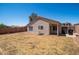 Home backyard featuring a patio, block fence, and desert landscaping at 11343 W Mccaslin Rose Ln, Surprise, AZ 85378