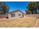 Backyard view showing small patio, desert landscaping, and block fence at 11343 W Mccaslin Rose Ln, Surprise, AZ 85378
