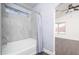 Bathroom with tile shower/tub featuring a shower curtain and view into another room at 11343 W Mccaslin Rose Ln, Surprise, AZ 85378