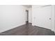 Small bedroom features hardwood floors, white walls and sliding-door closet at 11343 W Mccaslin Rose Ln, Surprise, AZ 85378