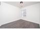 Empty bedroom with stylish floors, neutral paint, and a window with blinds at 11343 W Mccaslin Rose Ln, Surprise, AZ 85378