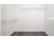 Walk-in closet featuring wire shelving, neutral paint, and stylish floors at 11343 W Mccaslin Rose Ln, Surprise, AZ 85378