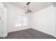 Inviting dining room with hardwood floors, modern lighting, and a large window at 11343 W Mccaslin Rose Ln, Surprise, AZ 85378