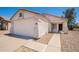 Close-up view of a well-maintained single-story home with a two-car garage and low-maintenance landscaping at 11343 W Mccaslin Rose Ln, Surprise, AZ 85378