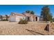 Lovely single-story home with low maintenance landscaping, a two-car garage, and inviting curb appeal at 11343 W Mccaslin Rose Ln, Surprise, AZ 85378