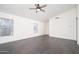 Bright living room featuring hardwood floors, natural light, and neutral paint at 11343 W Mccaslin Rose Ln, Surprise, AZ 85378