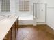 Bright bathroom with a glass shower, soaking tub, and tiled floor at 12644 N 152Nd Ave, Surprise, AZ 85379