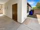 Exterior garage door with walkway and a trash can at 12644 N 152Nd Ave, Surprise, AZ 85379