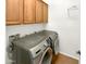 Laundry room featuring a washer and dryer along with built-in cabinets for storage at 12644 N 152Nd Ave, Surprise, AZ 85379