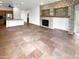Spacious living room with tile flooring and a stone fireplace with wooden mantle at 12644 N 152Nd Ave, Surprise, AZ 85379