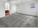 Neutral carpeted bedroom with a ceiling fan and an ensuite bathroom entrance at 12644 N 152Nd Ave, Surprise, AZ 85379