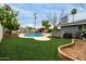 An inviting backyard featuring a refreshing pool, lush green grass and outdoor amenities at 1316 E Vermont Ave, Phoenix, AZ 85014