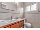 Updated bathroom with modern fixtures, a sleek vanity, and stylish tiled accents at 1316 E Vermont Ave, Phoenix, AZ 85014