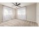 Bright bedroom with a ceiling fan, soft carpet, and sheer curtains for diffused natural light at 1316 E Vermont Ave, Phoenix, AZ 85014