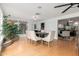 Bright dining room features a modern table with seating for eight and large windows at 1316 E Vermont Ave, Phoenix, AZ 85014