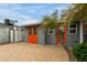 Charming exterior view highlighting stylish doors, mature palm trees, and ample paved space at 1316 E Vermont Ave, Phoenix, AZ 85014