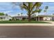Charming single-story home with a gray exterior, well-manicured lawn, and a spacious carport at 1316 E Vermont Ave, Phoenix, AZ 85014