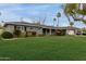 Charming single-story home featuring lush landscaping, a well-manicured lawn, and a covered parking area at 1316 E Vermont Ave, Phoenix, AZ 85014