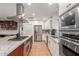 Bright kitchen with stainless steel appliances, white cabinets, and a large kitchen island at 1316 E Vermont Ave, Phoenix, AZ 85014