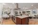 Open-concept kitchen with an island, stainless steel appliances, and adjacent living space at 1316 E Vermont Ave, Phoenix, AZ 85014