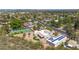 View of a sprawling estate with solar panels and a tennis court, surrounded by lush greenery in a residential area at 14814 N Coral Gables Dr, Phoenix, AZ 85023