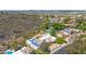 Beautiful home featuring solar panels and a tennis court, set against a stunning mountain and neighborhood backdrop at 14814 N Coral Gables Dr, Phoenix, AZ 85023