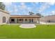 Back exterior view of a home with a covered patio and manicured lawn at 14814 N Coral Gables Dr, Phoenix, AZ 85023
