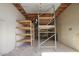 Bright garage featuring shelving units, overhead lighting, and a clean concrete floor at 14814 N Coral Gables Dr, Phoenix, AZ 85023