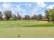 Scenic golf course view with lush green grass, mature trees, and blue skies perfect for a relaxing day on the greens at 14814 N Coral Gables Dr, Phoenix, AZ 85023