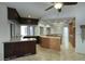 Spacious kitchen featuring dark wood cabinetry, granite countertops, and a large window at 14814 N Coral Gables Dr, Phoenix, AZ 85023
