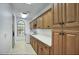 Well-organized laundry room with ample cabinet space, a utility sink, and a bright window at 14814 N Coral Gables Dr, Phoenix, AZ 85023