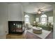Comfortable living room featuring a fireplace, arched windows, and stylish decor at 14814 N Coral Gables Dr, Phoenix, AZ 85023
