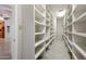 Spacious walk-in pantry with extensive shelving for organized storage at 14814 N Coral Gables Dr, Phoenix, AZ 85023