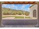 Back patio with brick flooring, light fixtures, and a desert view at 14814 N Coral Gables Dr, Phoenix, AZ 85023