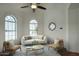 Bright sitting room with arched windows, comfortable seating, and decorative window at 14814 N Coral Gables Dr, Phoenix, AZ 85023