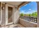 Cozy balcony view with decorative railing overlooking mature trees and clear blue skies at 15221 N Clubgate Dr # 2132, Scottsdale, AZ 85254